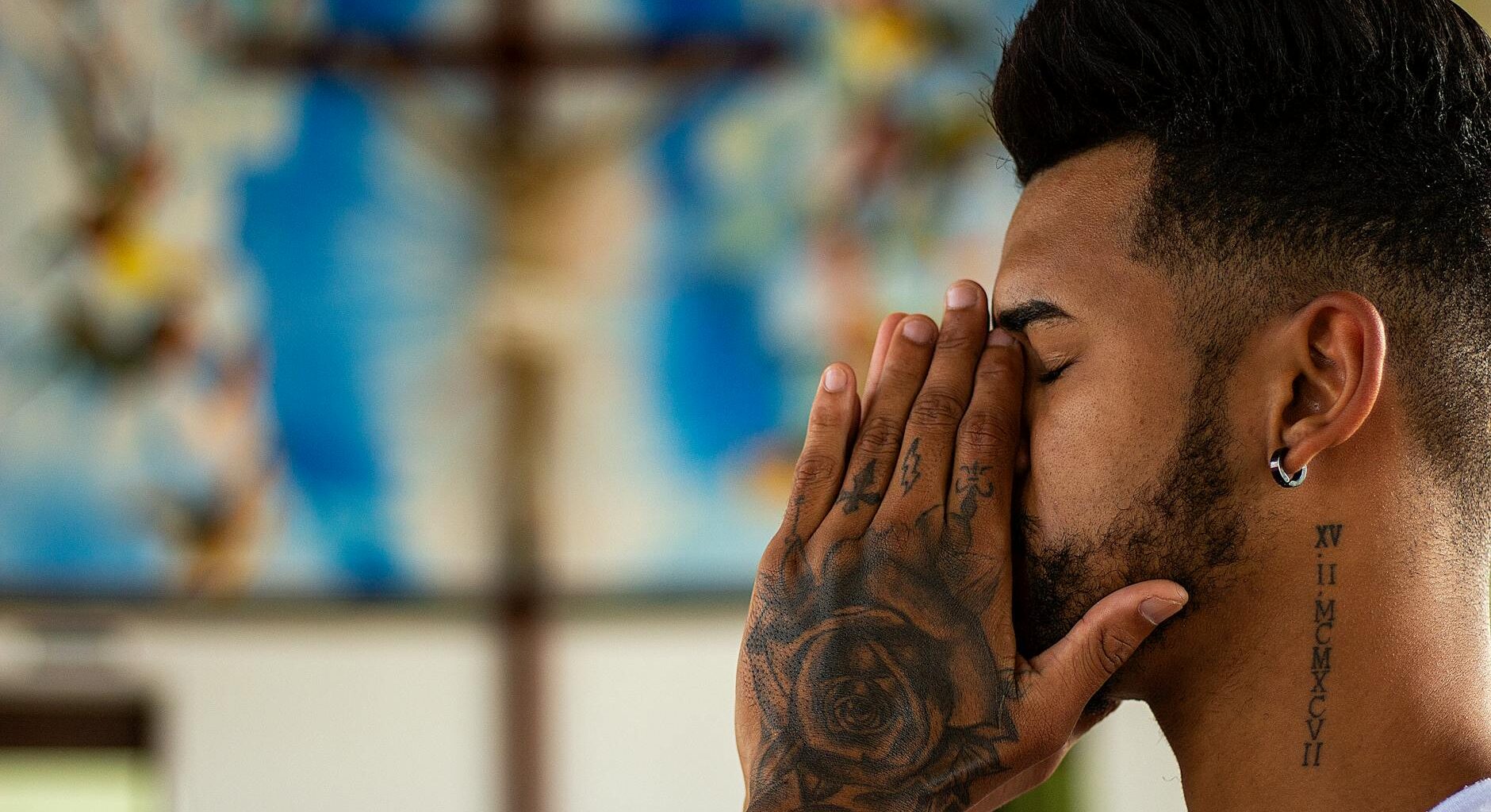 closed eyed man holding his face using both of his hands