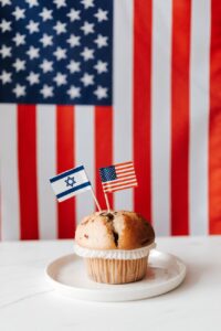 tasty muffin with national flags of usa and israel