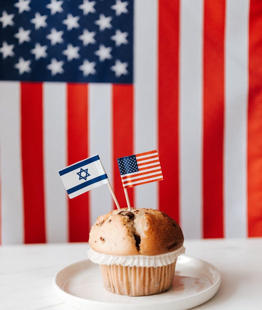 tasty muffin with national flags of usa and israel