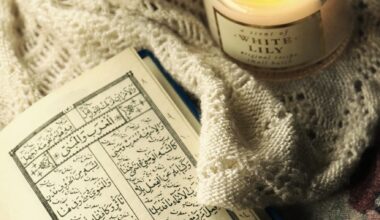 photo of quran beside lighted candle