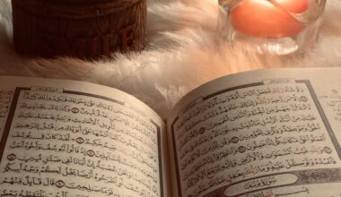 photo of an open book beside red lighted candle