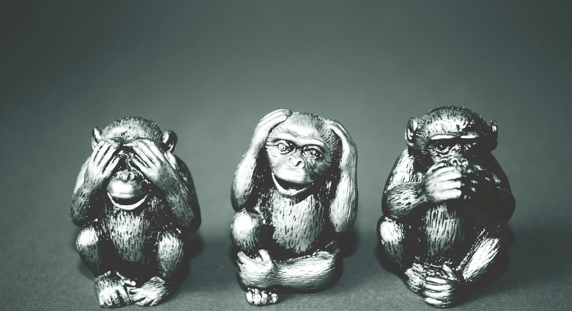 grayscale photography of three wise monkey figurines