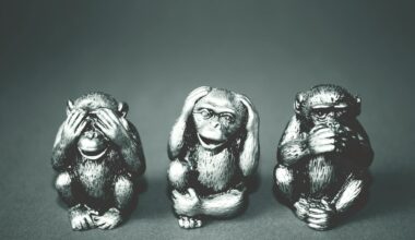 grayscale photography of three wise monkey figurines