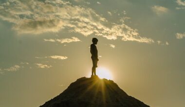 silhouette of a man standing on a mountain