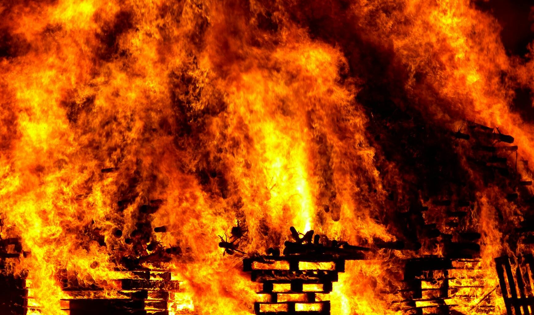 flare of fire on wood with black smokes