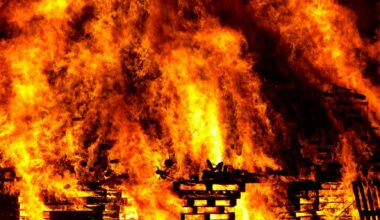 flare of fire on wood with black smokes