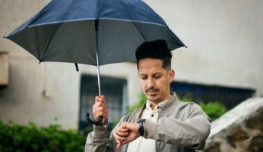 man with umbrella checking watch outdoors in algeria