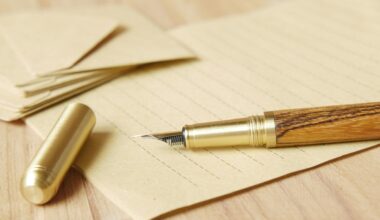 gold and wooden fountain pen on brown envelope