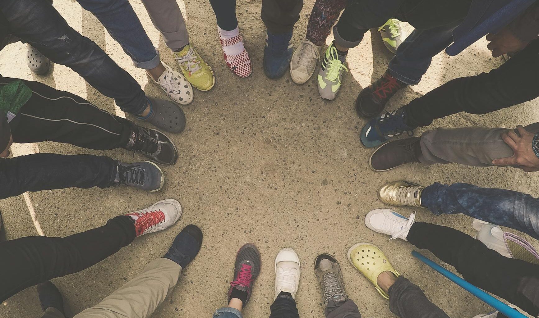 group of people standing on pavement