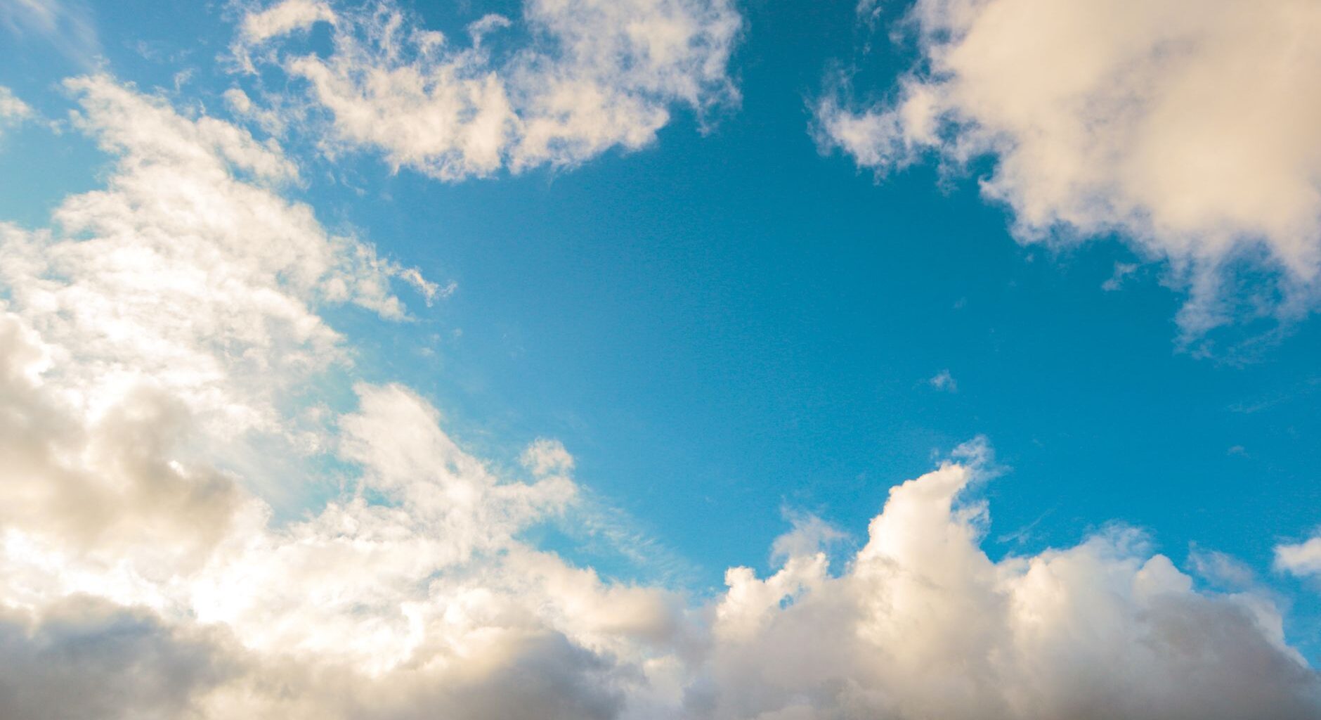 vibrant blue sky with fluffy clouds