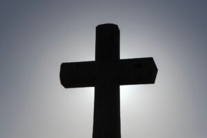 silhouette of a cross against the sky