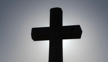 silhouette of a cross against the sky