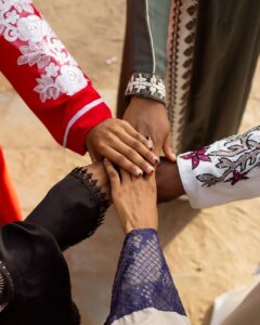 diverse hands joined in solidarity outdoors