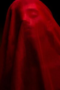 a person covered with red cloth