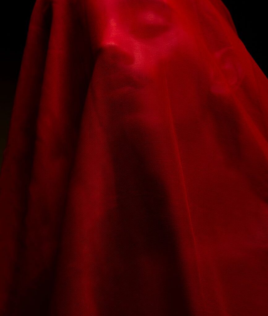 a person covered with red cloth