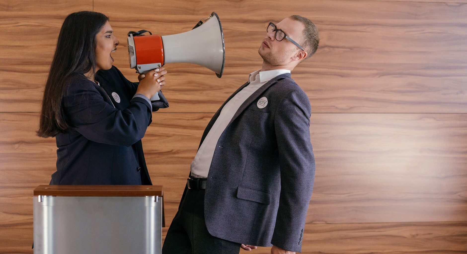 woman shouts on man using megaphone