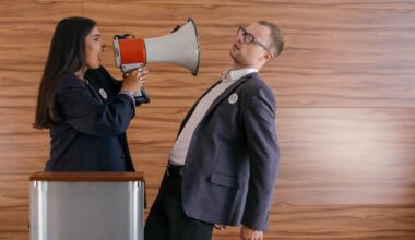 woman shouts on man using megaphone